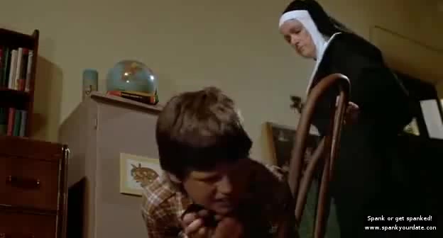 Mean Nun spanking a boy with a belt  